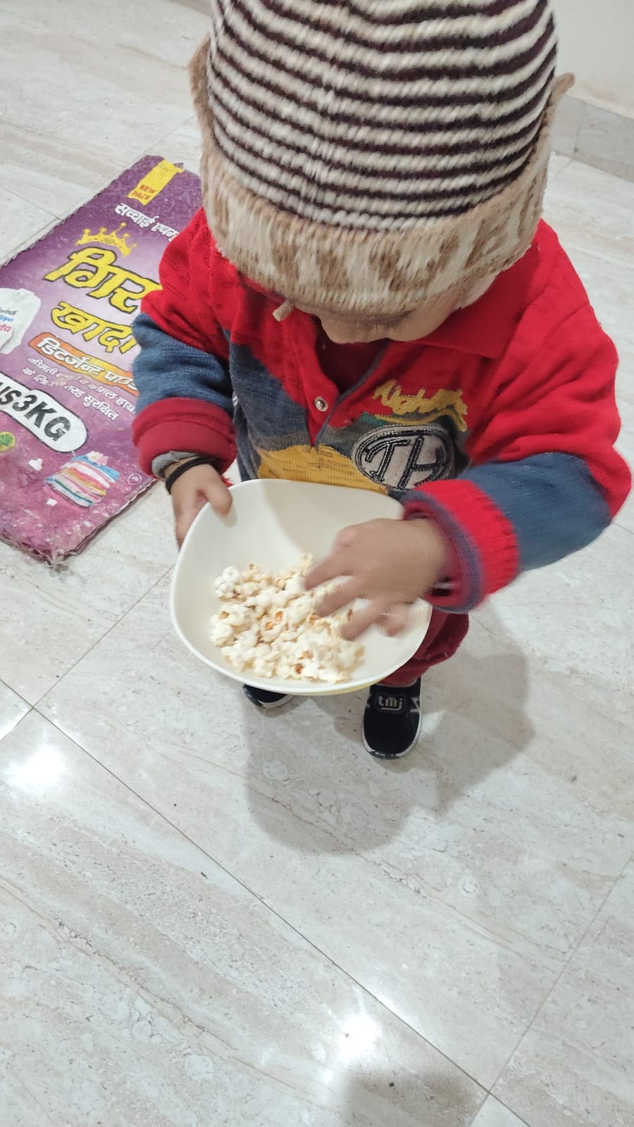 Child enjoying snack time at PnP Day Care